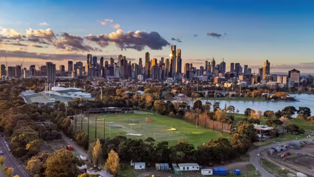 Melbourne, Victoria, Australia - Aerial view of Albert Park lake, golf driving range and Melbourne city skyline at sunset.