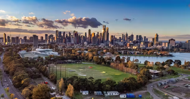 Melbourne, Victoria, Australia - Aerial view of Albert Park lake, golf driving range and Melbourne city skyline at sunset.