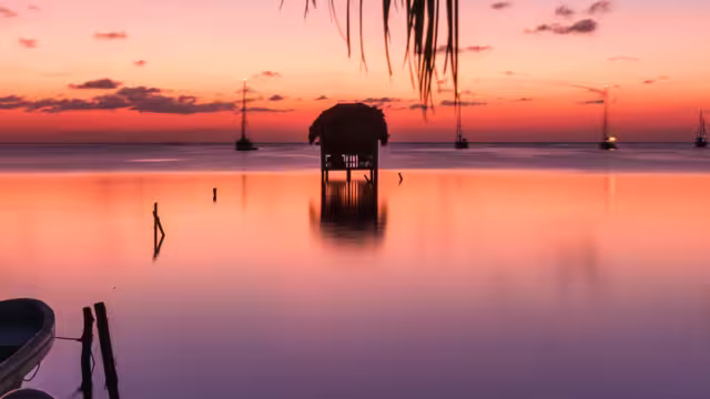 Traveller enjoying the sunset, Caye Caulker, Belize