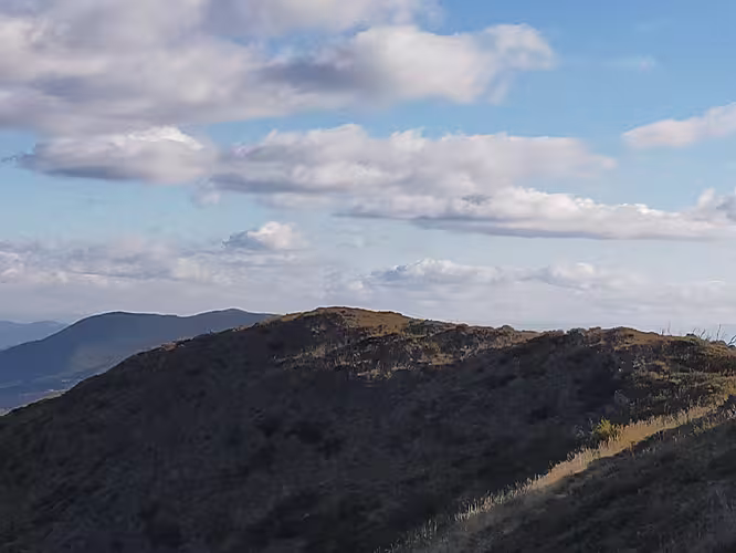 Group of hikers hiking across mountains in the Victoria High Country, Australia