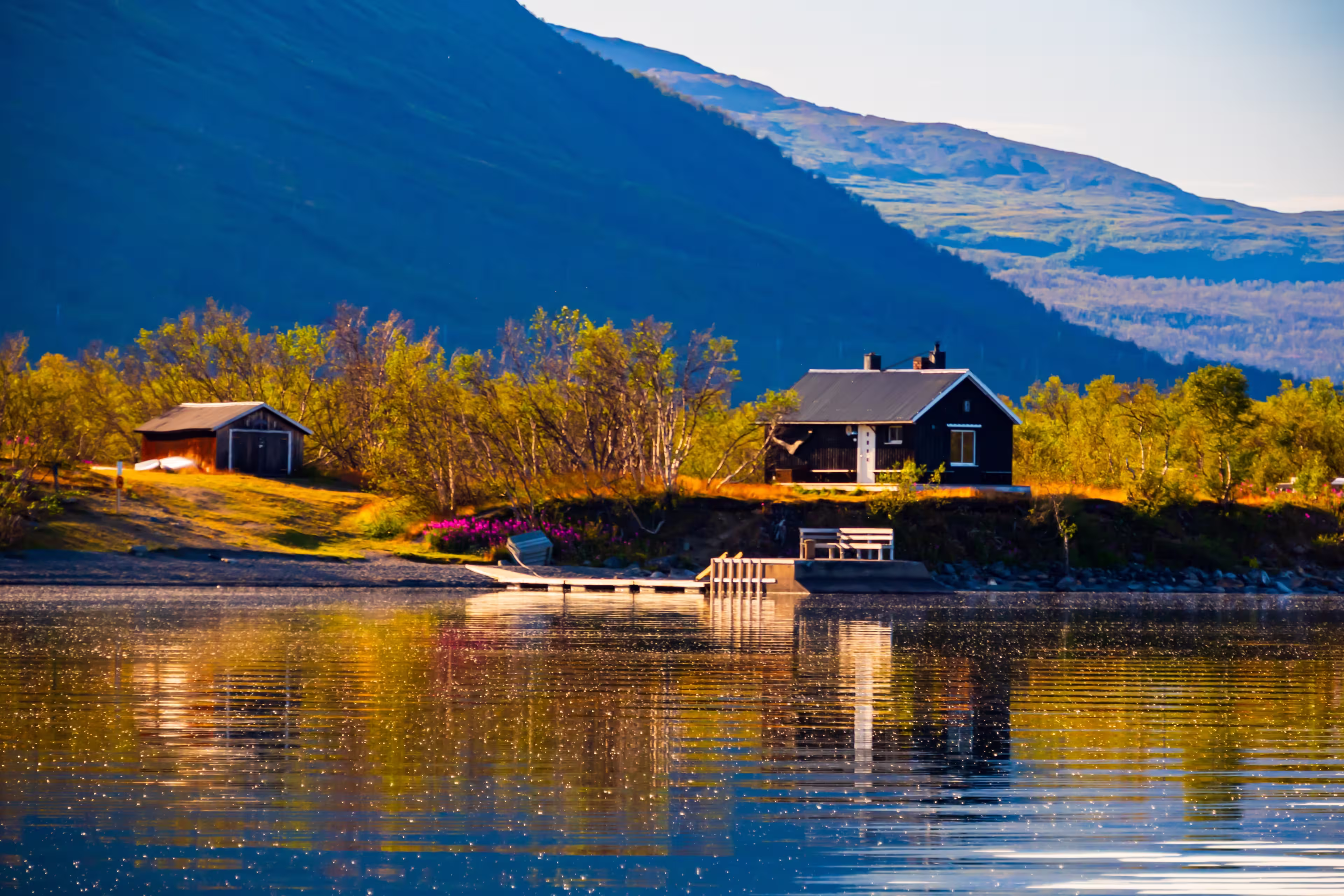 Cottage over the Torneträsk lake,  Tornetrask lake, träsk is a lake in Kiruna Municipality, Lapland, Norrbotten County in Sweden, in the Scandinavian Mountains. Abisko National Park