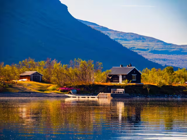 Cottage over the Torneträsk lake, Tornetrask lake, träsk is a lake in Kiruna Municipality, Lapland, Norrbotten County in Sweden, in the Scandinavian Mountains. Abisko National Park