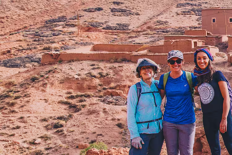Group of travellers standing before Ait Benhaddou fortified village, Morocco