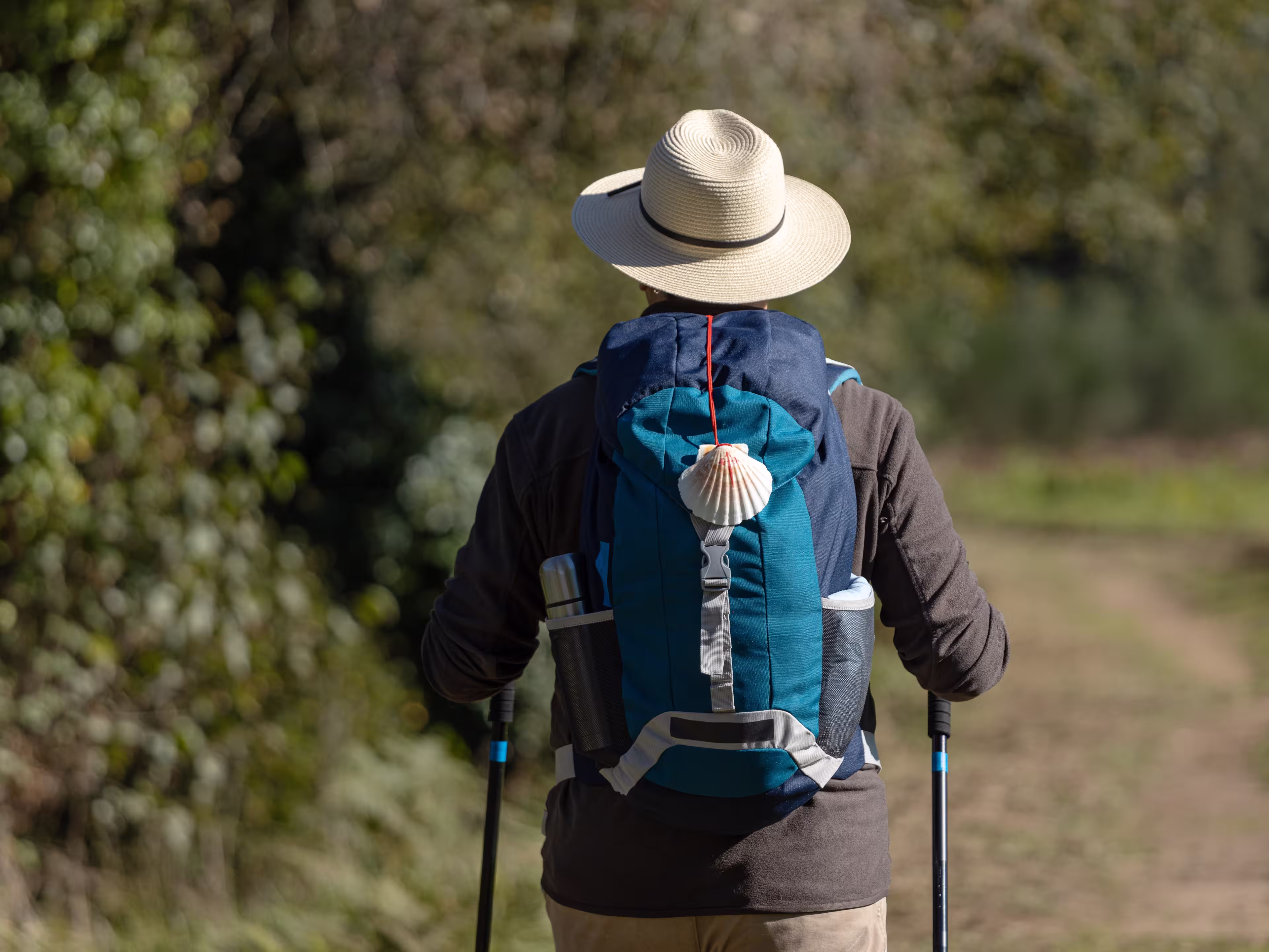 View from behind of a pilgrim walking on his way to Santiago de Compostela on a rural way. Way of saint james, Camino de Santiago