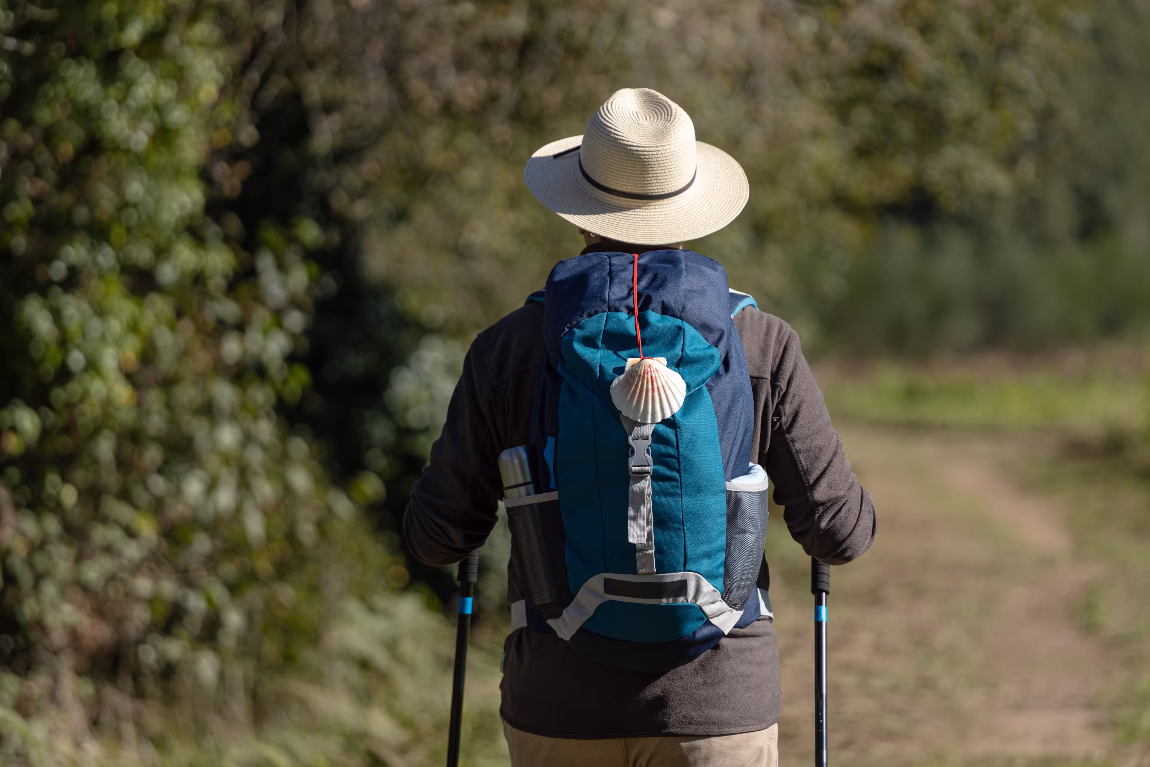 View from behind of a pilgrim walking on his way to Santiago de Compostela on a rural way. Way of saint james, Camino de Santiago