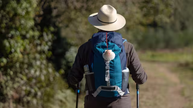 View from behind of a pilgrim walking on his way to Santiago de Compostela on a rural way. Way of saint james, Camino de Santiago