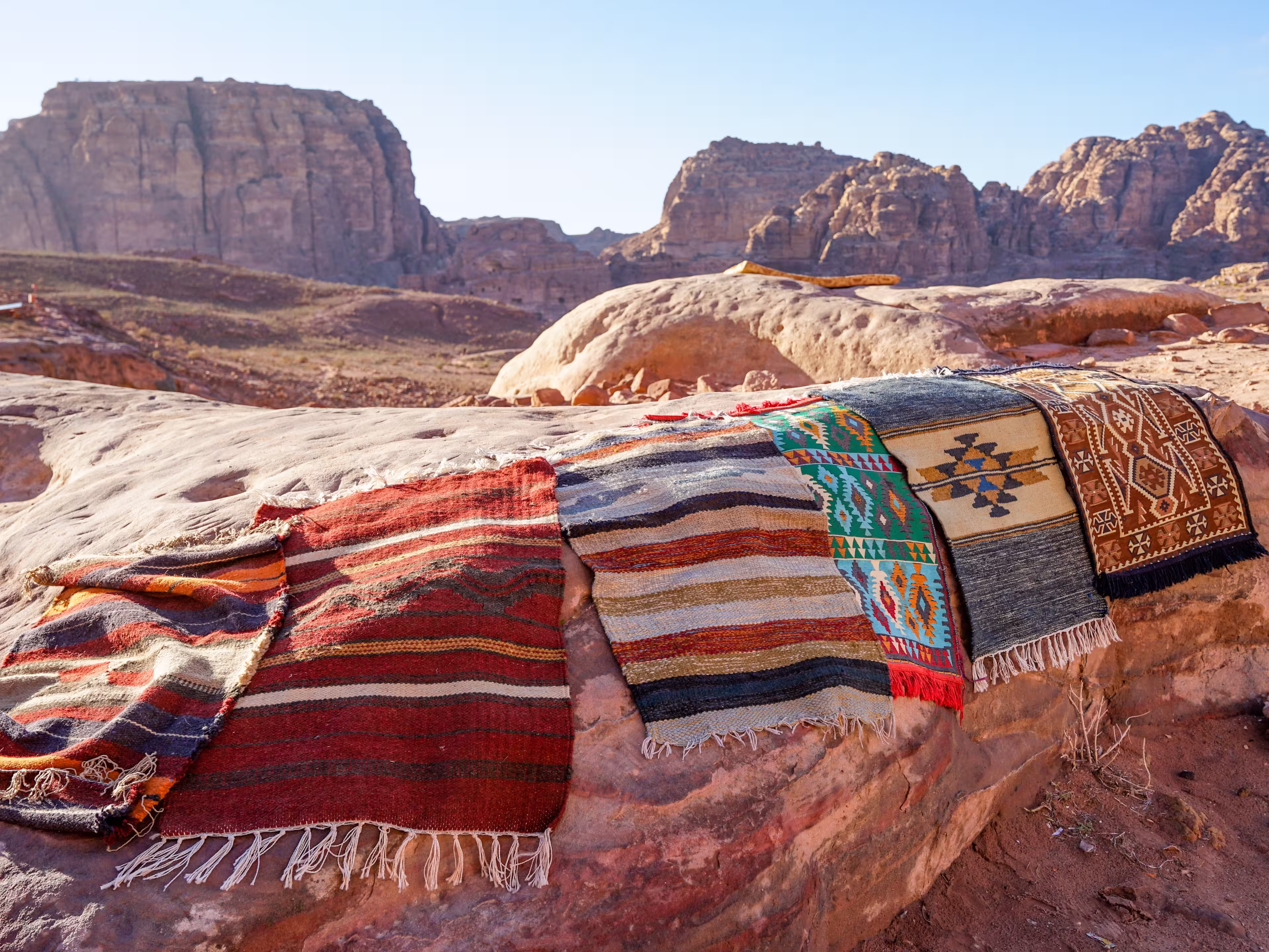 Colourful handmade bedouin rugs on stone, Petra, Jordan