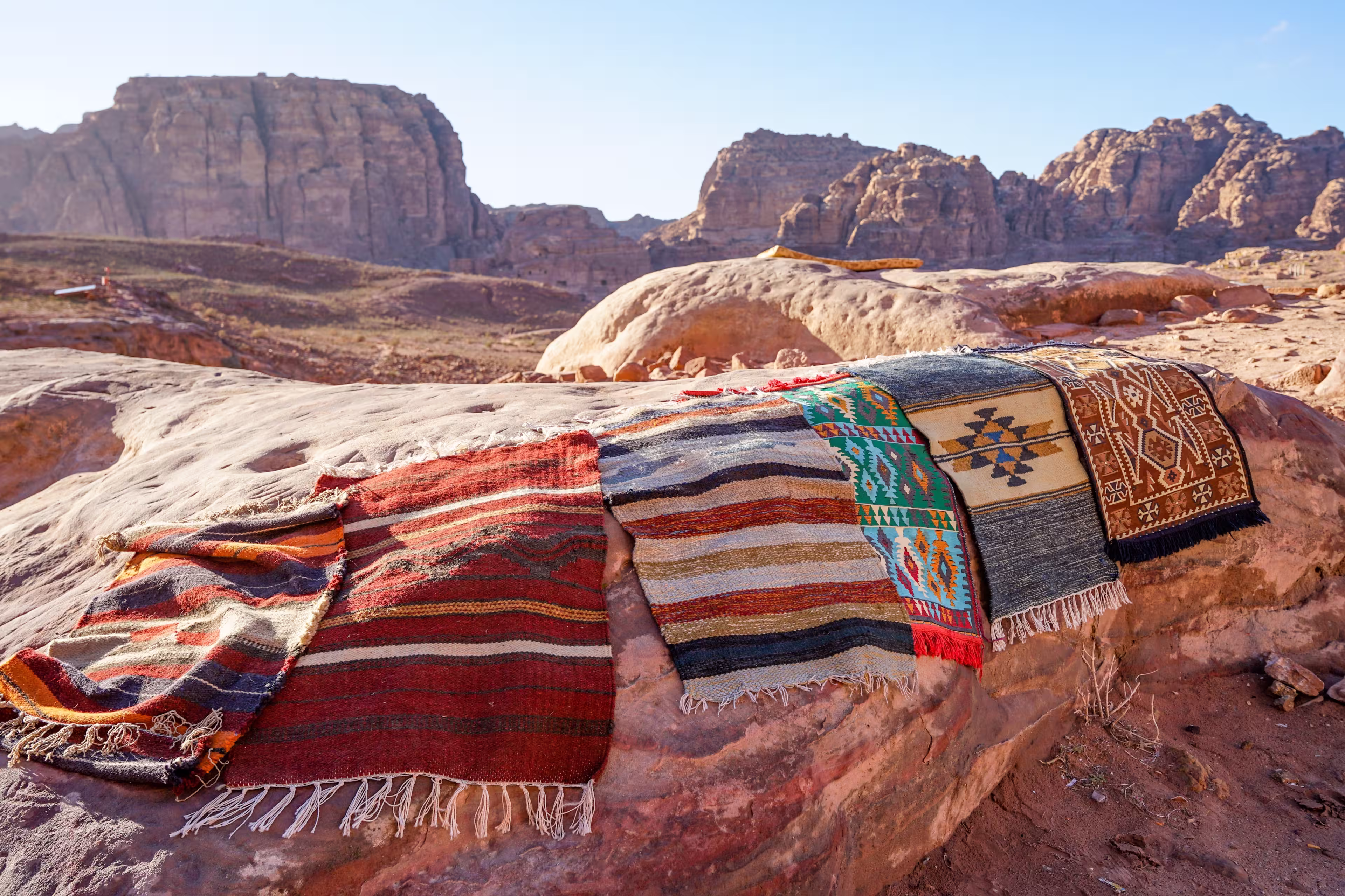 Colourful handmade bedouin rugs on stone, Petra, Jordan