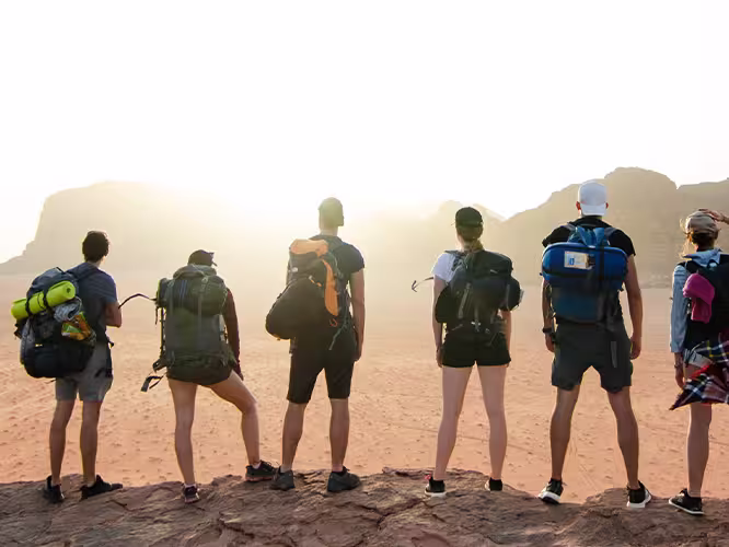 Group of hikers overlooking the desert in Wadi Rum, Jordan