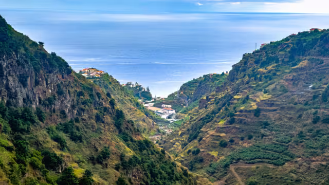 Hinking trail along Levada do Moinho and Levada Nova, revealing lush vegetation, waterfall and water canal to local town.