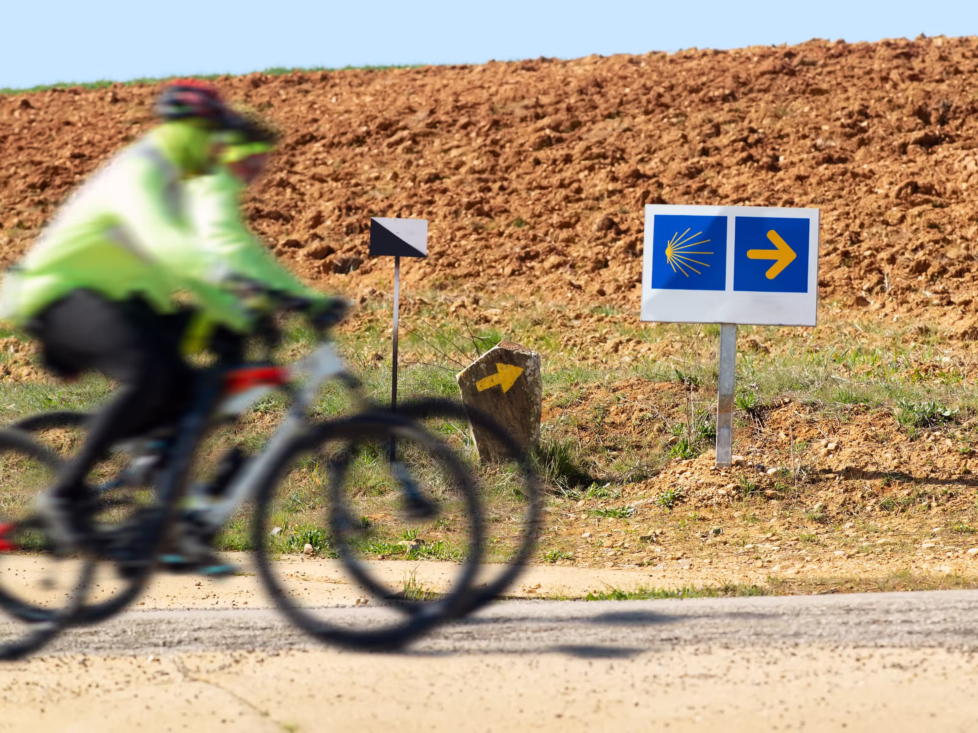 Way of St James , Camino de Santiago , pilgrims cycling unfocuseds  to Compostela near Astorga , Leon, Spain
