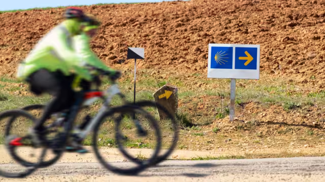 Way of St James , Camino de Santiago , pilgrims cycling unfocuseds  to Compostela near Astorga , Leon, Spain