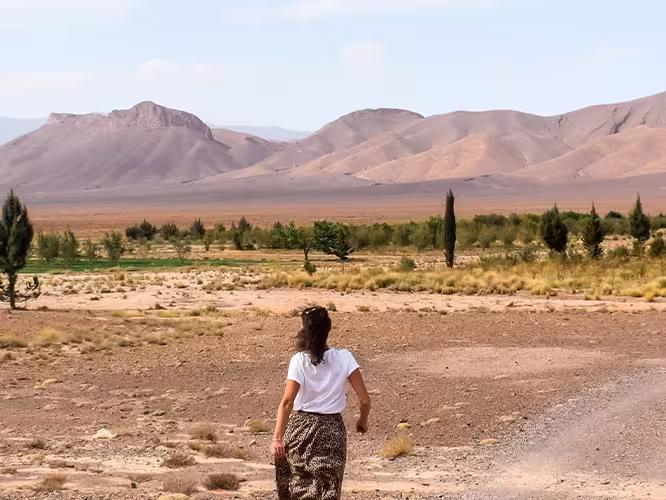 Female traveller walking towards the Atlas Mountains in Morocco