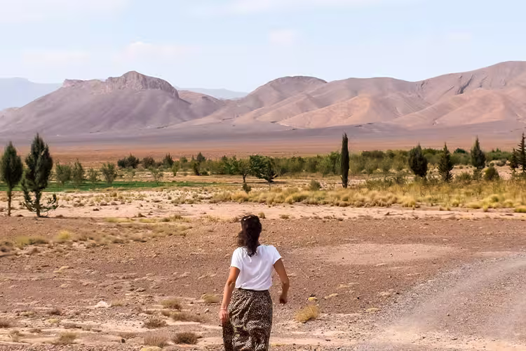 Female traveller walking towards the Atlas Mountains in Morocco
