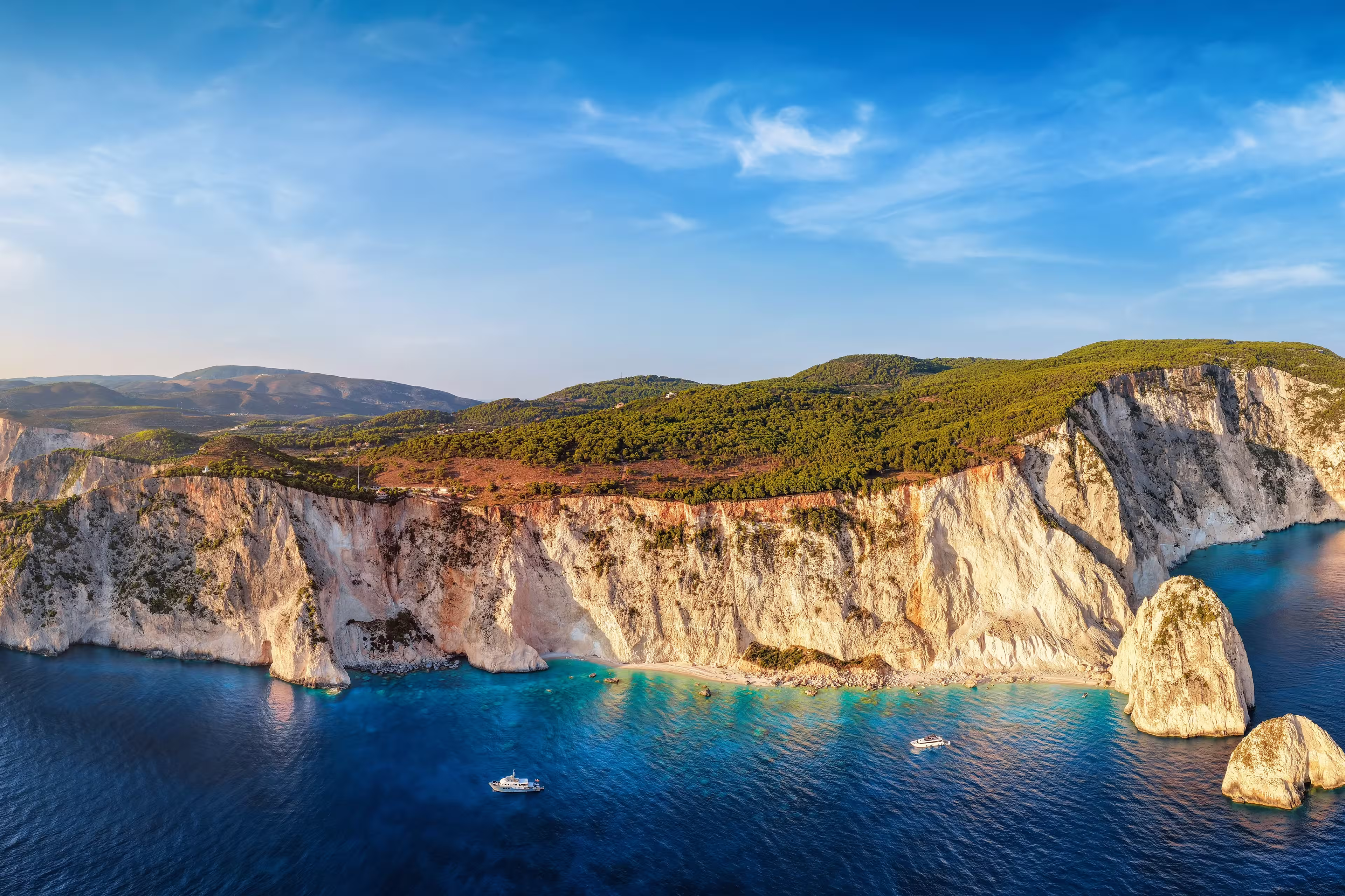 Aerial sunset view of the south coast of Zakynthos island, Greece, with the famous beaches and caves at the Keri area, viewpoint and lighthouse