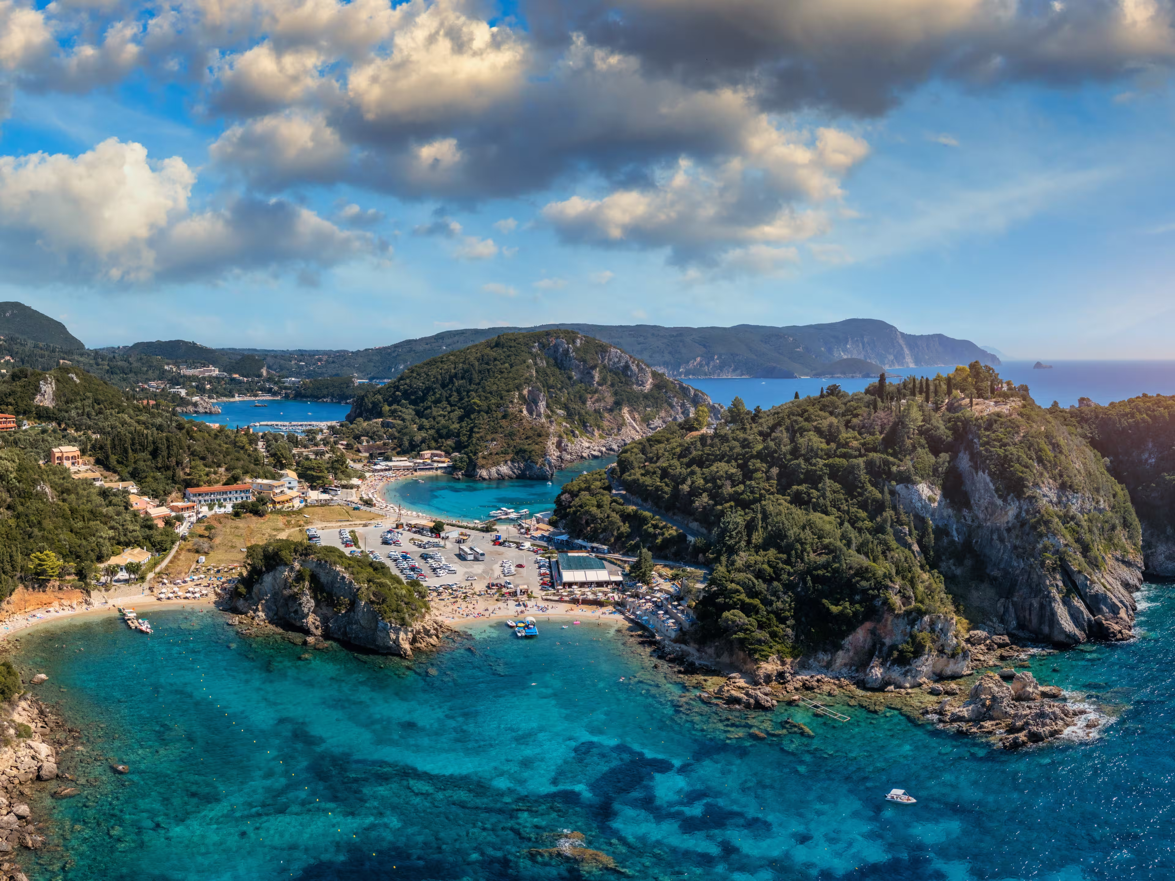 Picturesque seaside of Paleokastritsa, Corfu, Greece. Beautiful bay in Paleokastritsa in Corfu island, Greece. Panoramic view of Palaiokastritsa, boats and beach Corfu, Greece