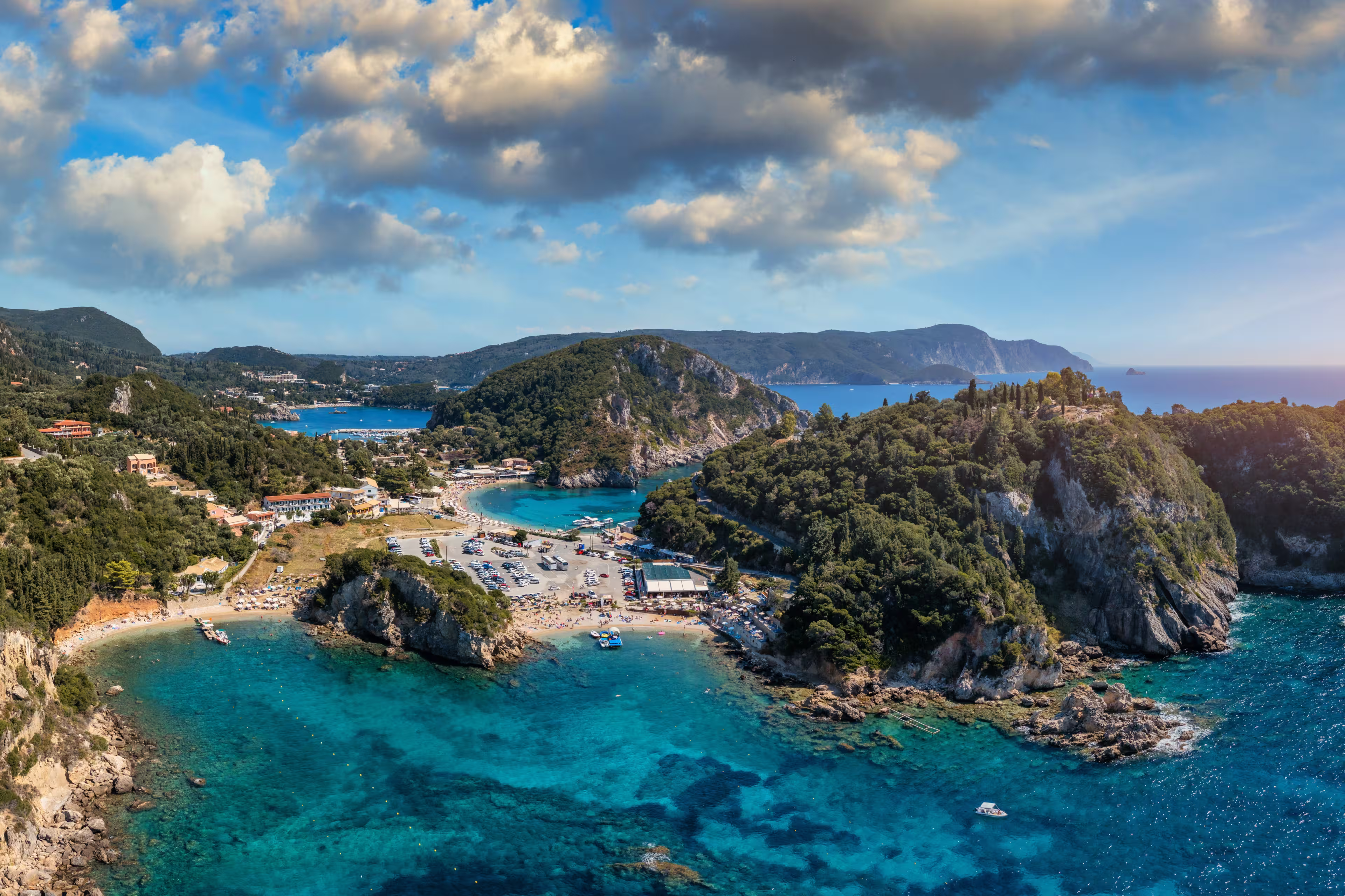 Picturesque seaside of Paleokastritsa, Corfu, Greece. Beautiful bay in Paleokastritsa in Corfu island, Greece. Panoramic view of Palaiokastritsa, boats and beach Corfu, Greece