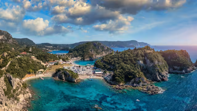 Picturesque seaside of Paleokastritsa, Corfu, Greece. Beautiful bay in Paleokastritsa in Corfu island, Greece. Panoramic view of Palaiokastritsa, boats and beach Corfu, Greece