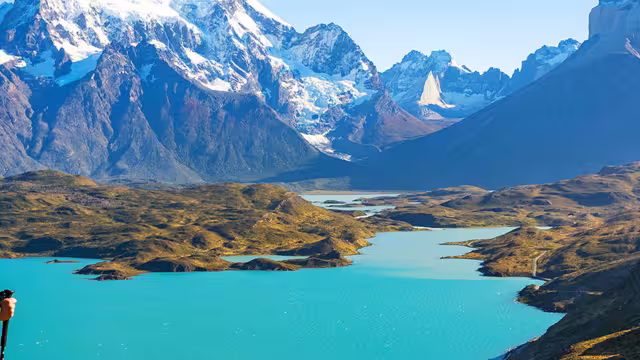 Hiker standing in front of the mountains in Torres del Paine NP, Chile