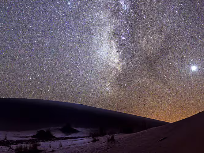 Traveller enjoying the Milky Way in the Sahara, Morocco