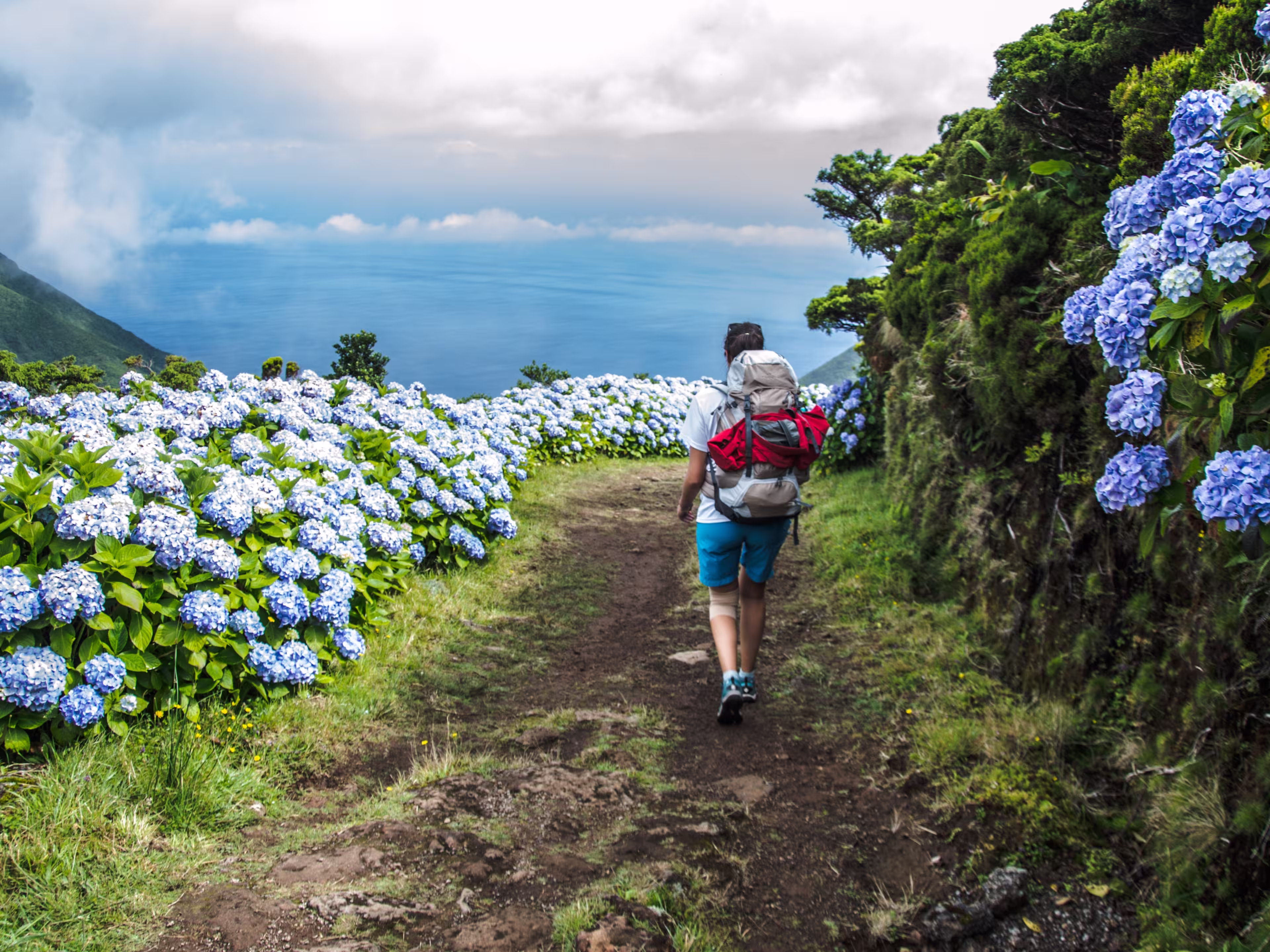 woman walking along an amazing trail in Sao Jorge