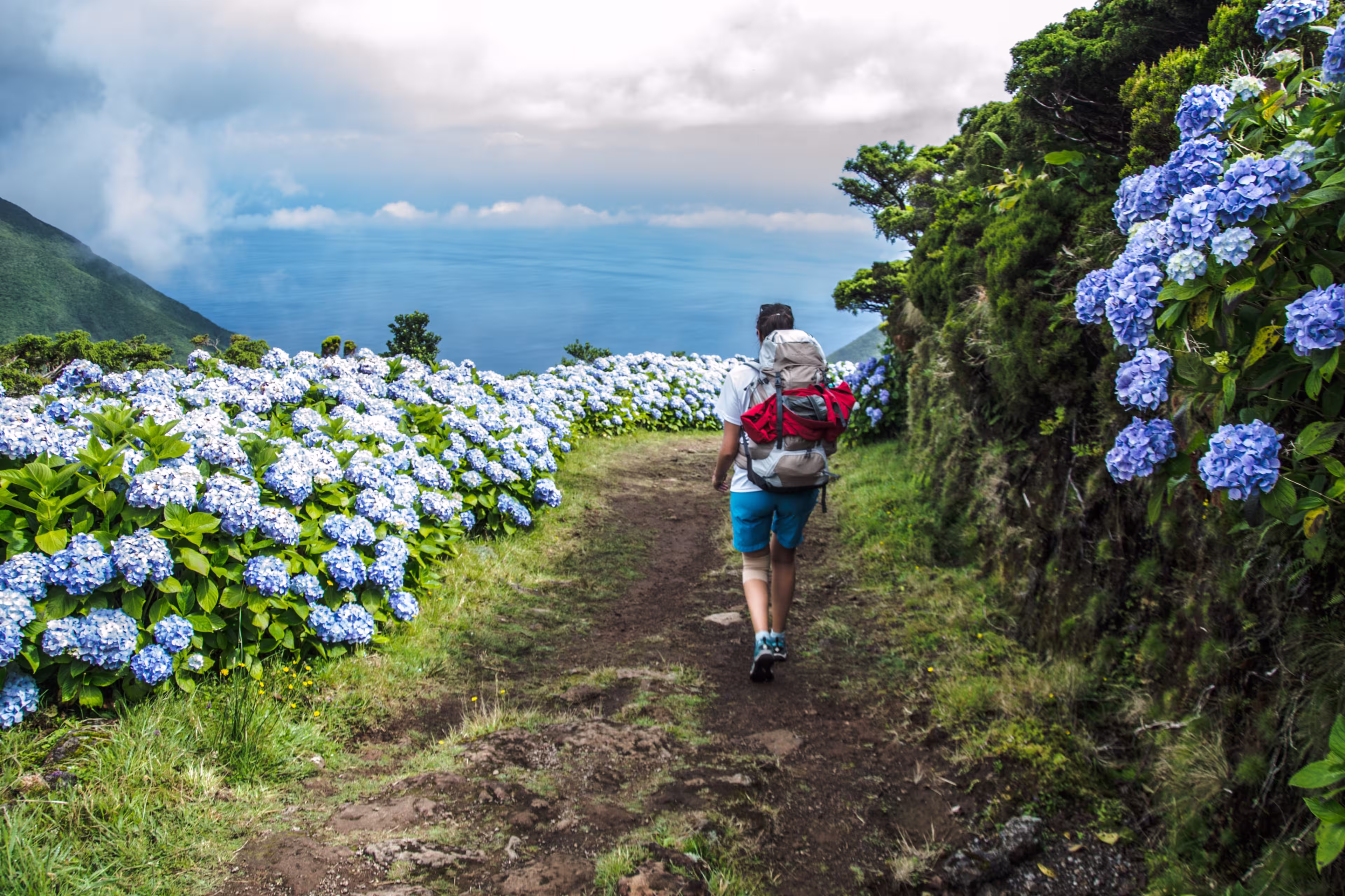 woman walking along an amazing trail in Sao Jorge