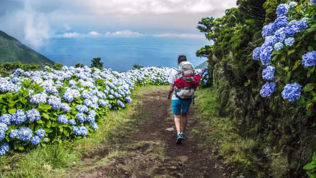 woman walking along an amazing trail in Sao Jorge