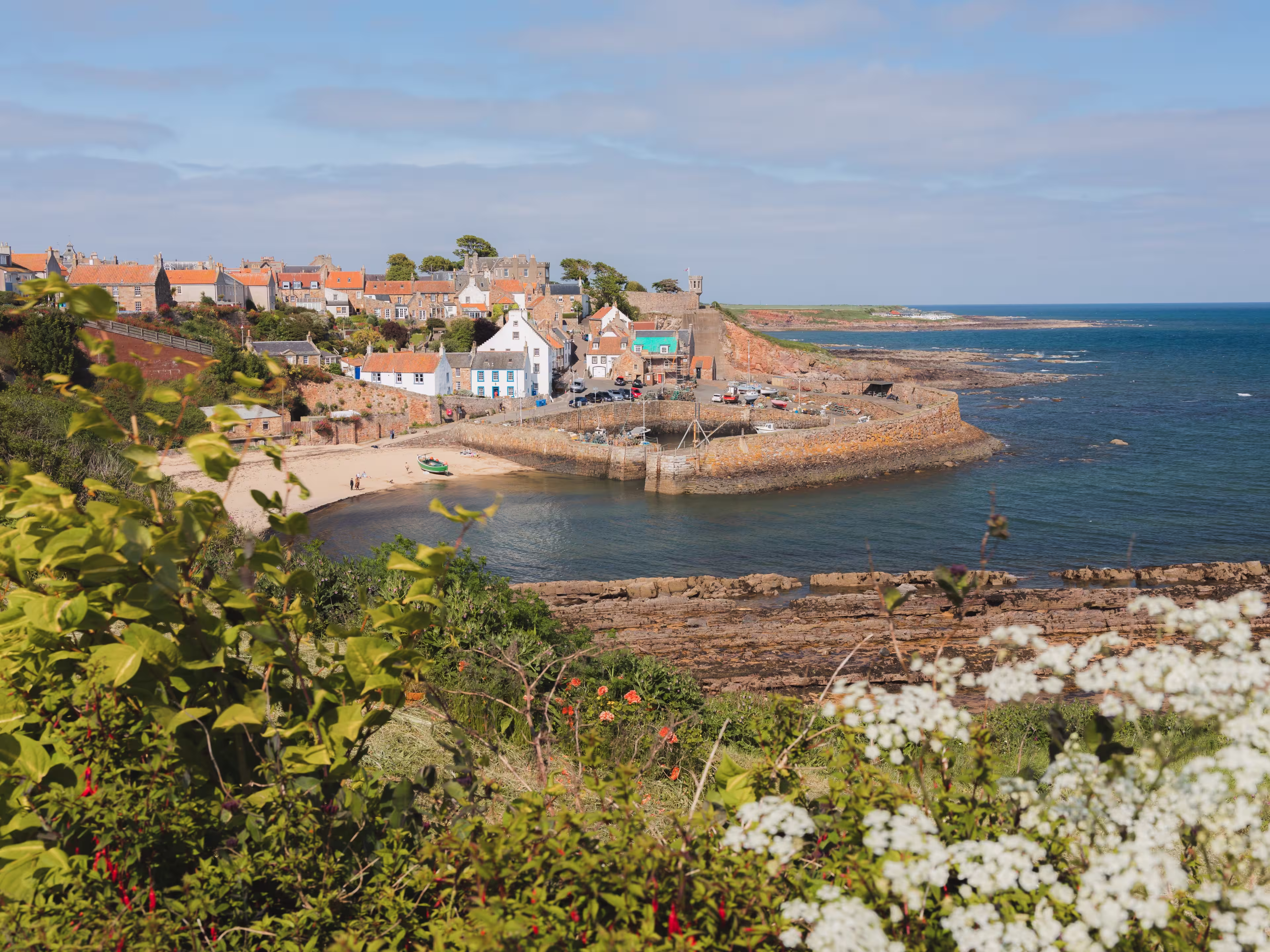 View of the quaint and picturesque harbour of the seaside fishing village Crail on a sunny summer day in East Neuk, Fife, Scotland.