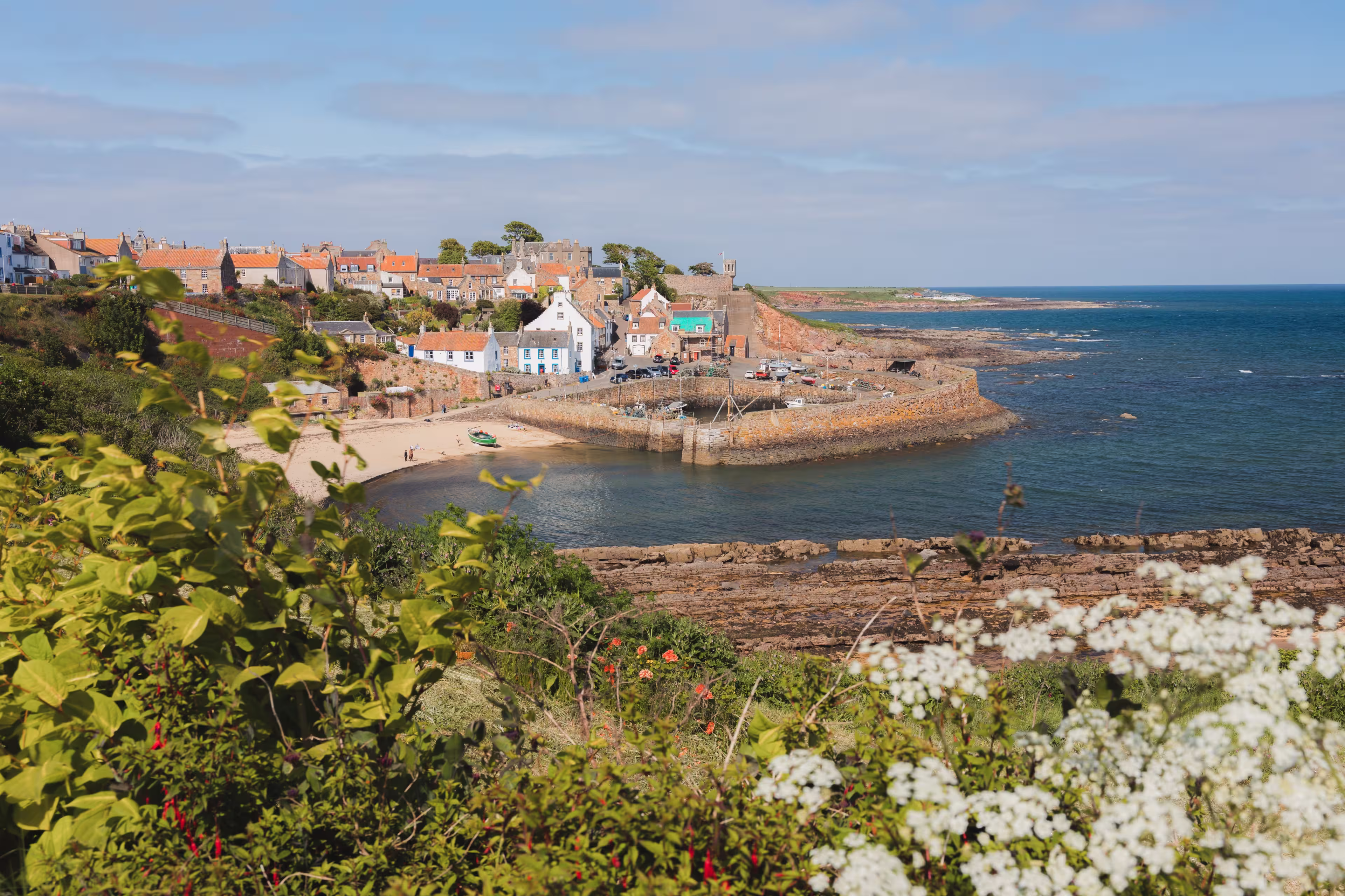 View of the quaint and picturesque harbour of the seaside fishing village Crail on a sunny summer day in East Neuk, Fife, Scotland.