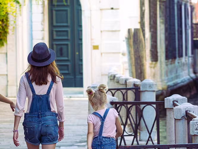 Mum and daughters walking around Venice. Italy