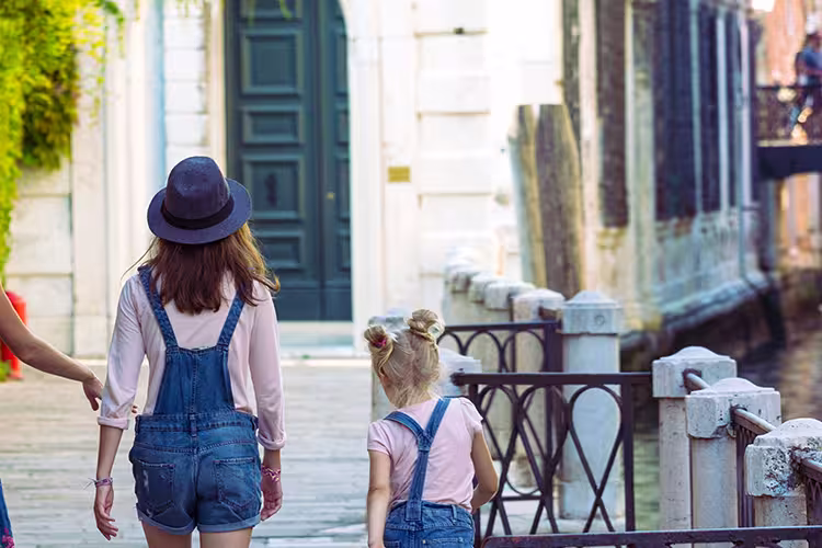 Mum and daughters walking around Venice. Italy