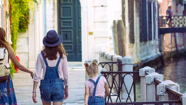 Mum and daughters walking around Venice. Italy