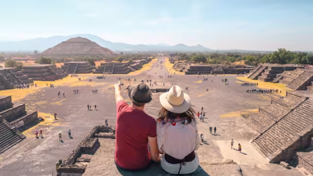 Travellers marvelling atop Teotihuacan in Mexico
