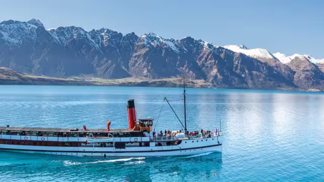 Boat by Queenstown with beautiful mountain backdrop, South Island, New Zealand