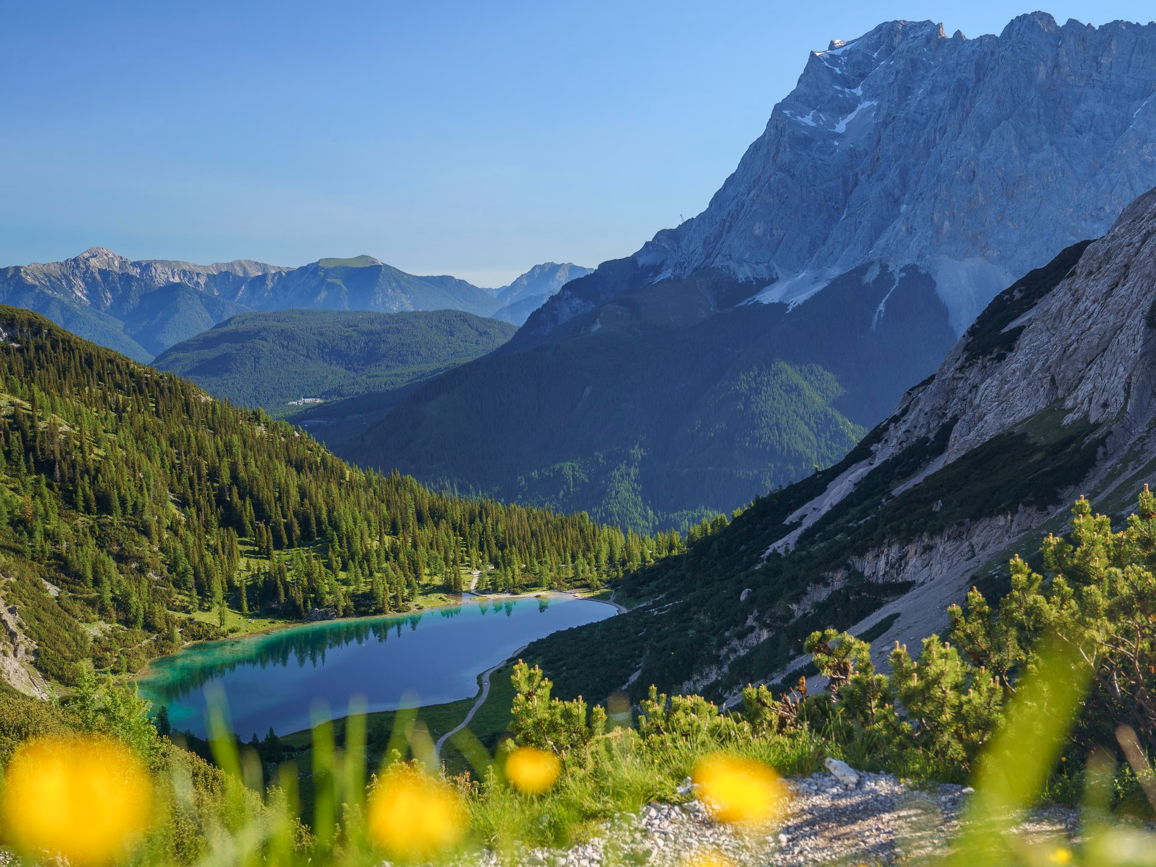 The Seebensee in Tirol, Austria, is surrounded by the high mountains of the Mieminger Range. In the background the Zugspitze and the Wetterstein Mountains. Seen from the Coburger Hütte.