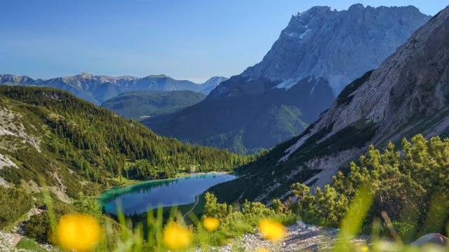 The Seebensee in Tirol, Austria, is surrounded by the high mountains of the Mieminger Range. In the background the Zugspitze and the Wetterstein Mountains. Seen from the Coburger Hütte.