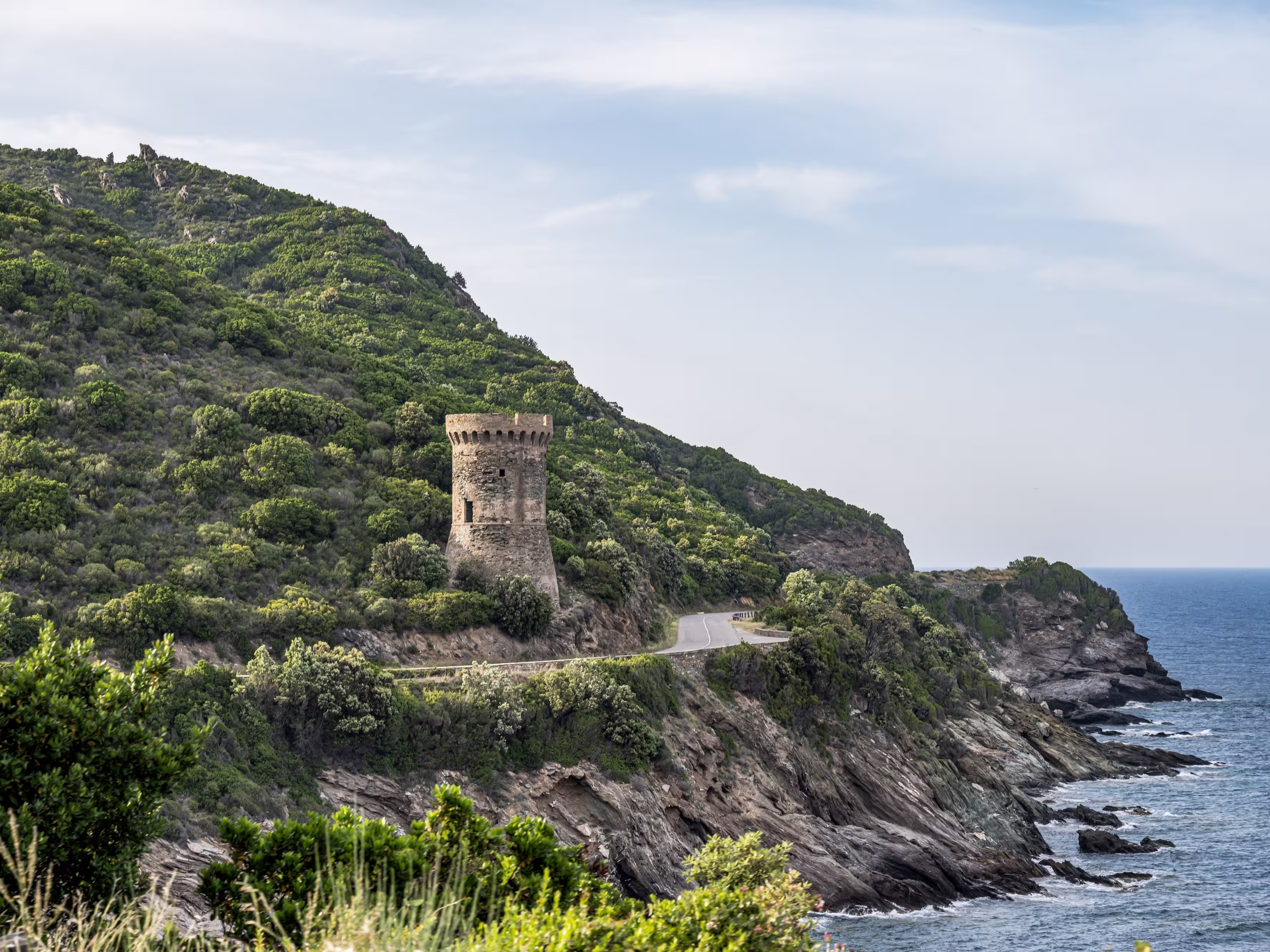 Watchtower view Roadtrip Winding road along rocky coast of Cap Corse peninsula on Corsica island France
