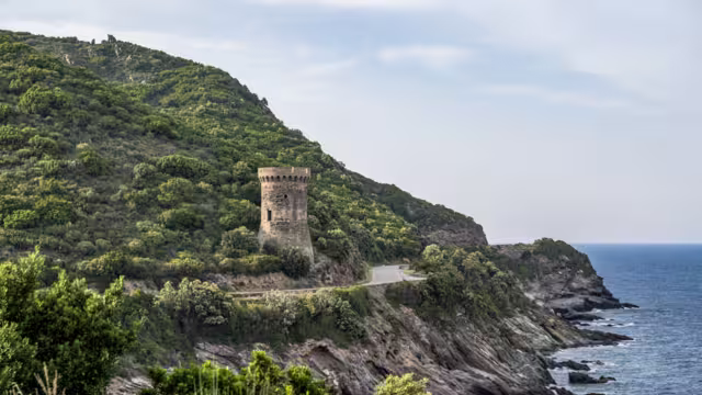 Watchtower view Roadtrip Winding road along rocky coast of Cap Corse peninsula on Corsica island France