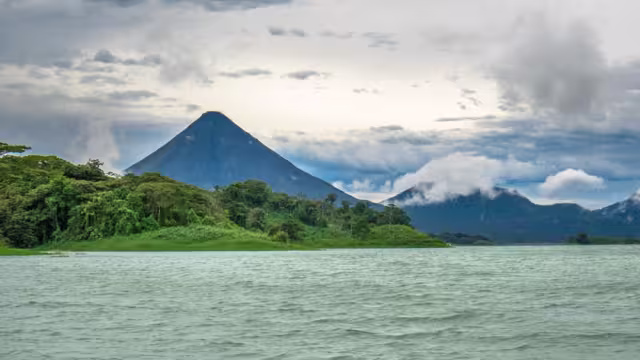 Arenal Volcano looms over the rainforests and waters of Costa Rica