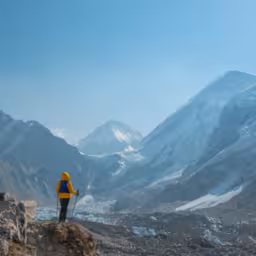 Male backpacker enjoying the view on mountain walk in Himalayas. Everest Base Camp trail route, Nepal trekking, Himalaya tourism. Travel, adventure, sport concept