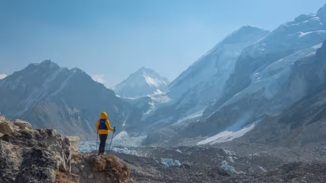 Male backpacker enjoying the view on mountain walk in Himalayas. Everest Base Camp trail route, Nepal trekking, Himalaya tourism. Travel, adventure, sport concept