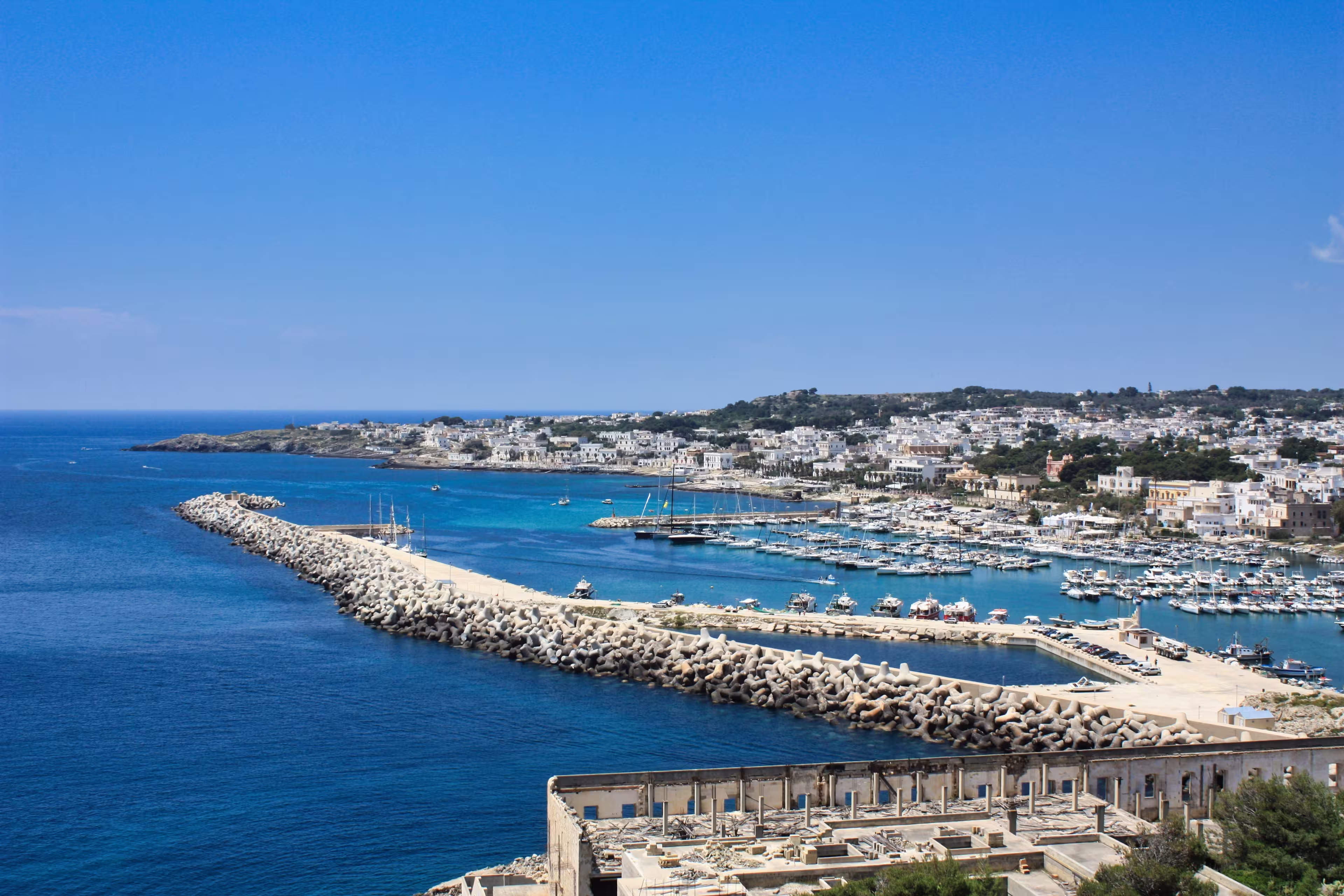 Overview of the harbour of Santa Maria di Leuca with beautiful clear water and a blue sky, Italy