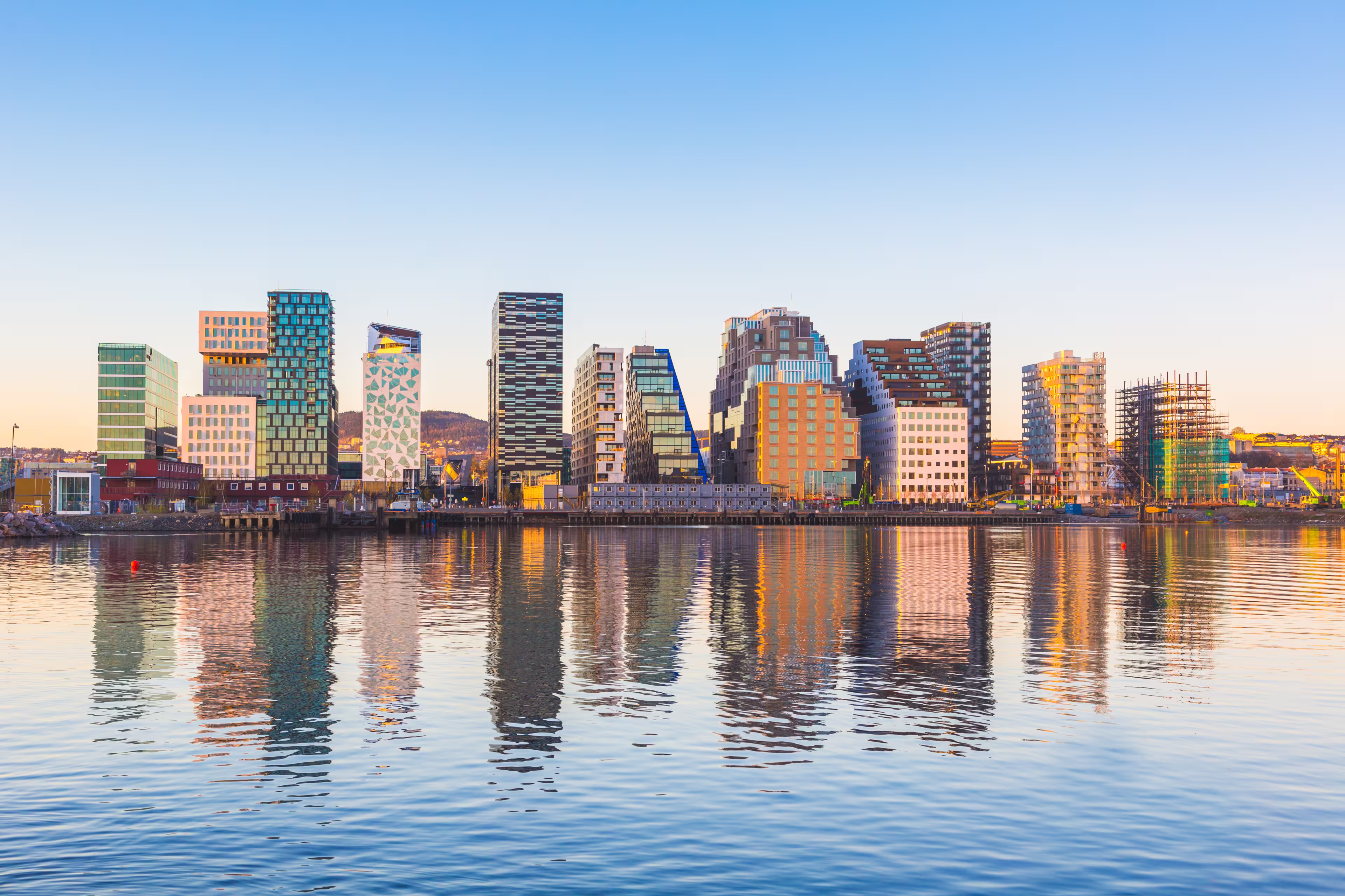Modern buildings in Oslo, Norway, with their reflection into the water. These are some of the new buildings in the neighbourhood of Bjorvika. Concepts of travel and architecture.