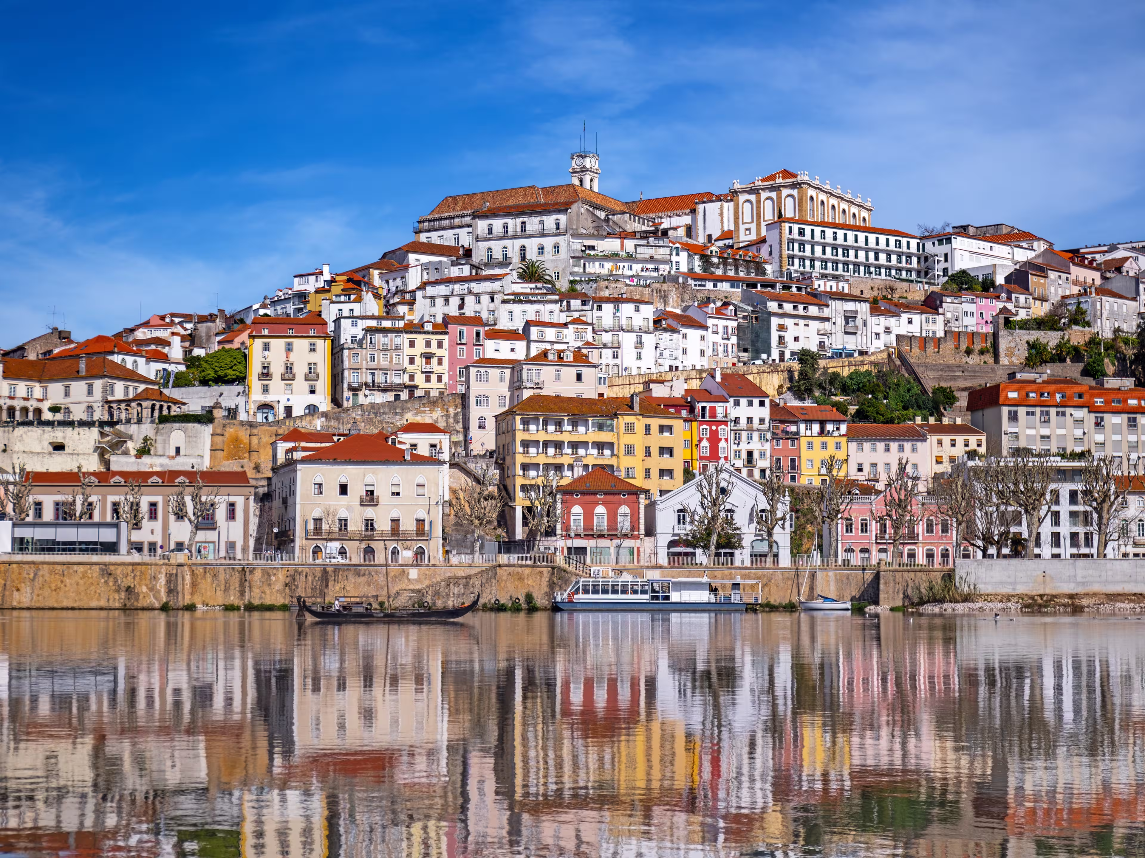 A picturesque panorama of Coimbra with the reflection in the Mondego river