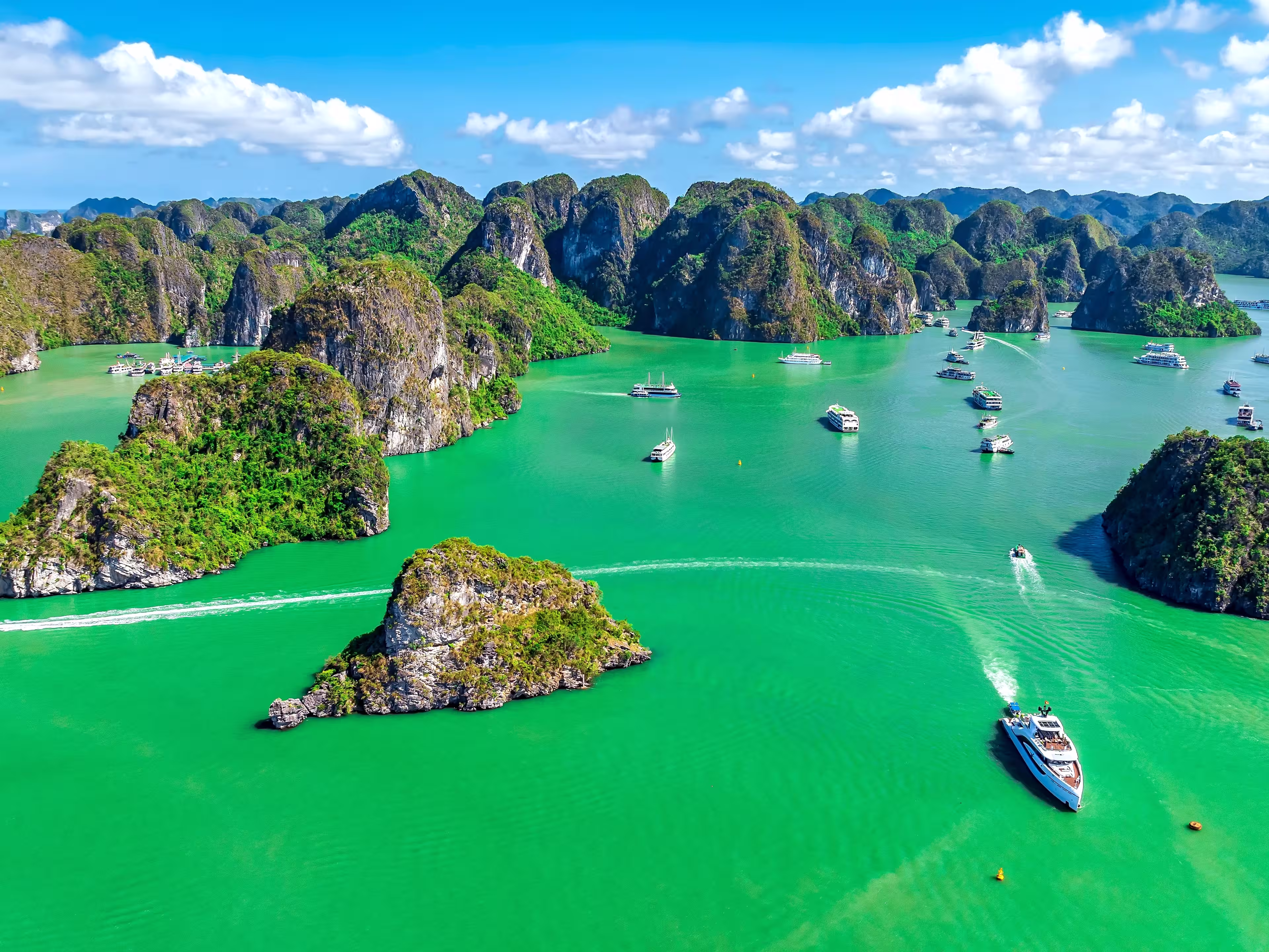 Aerial view of Scenic Halong Bay, Vietnam with boats amongst limestone islands. UNESCO World Heritage Site. Popular landmark, famous destination of Vietnam