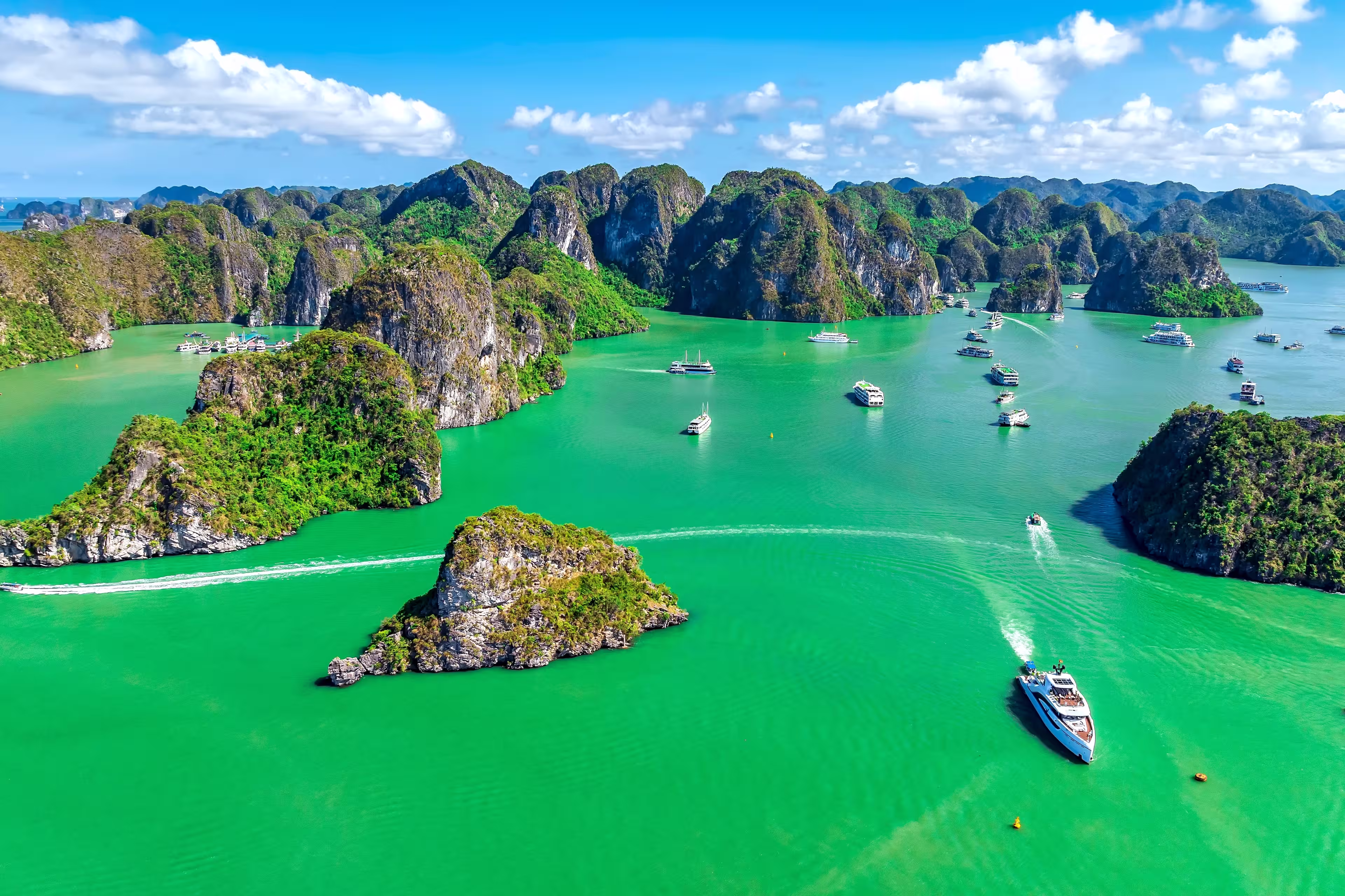 Aerial view of Scenic Halong Bay, Vietnam with boats amongst limestone islands. UNESCO World Heritage Site. Popular landmark, famous destination of Vietnam
