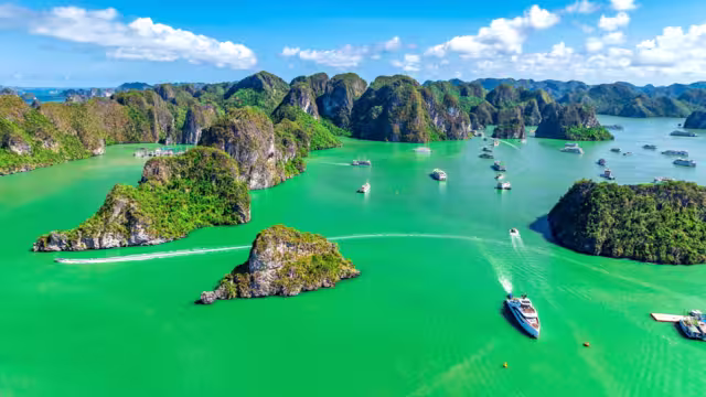 Aerial view of Scenic Halong Bay, Vietnam with boats amongst limestone islands. UNESCO World Heritage Site. Popular landmark, famous destination of Vietnam