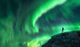 Northern lights and young woman on mountain peak at night. Aurora borealis and silhouette of alone girl on top of rock. Landscape with polar lights. Starry sky with bright aurora. Travel background