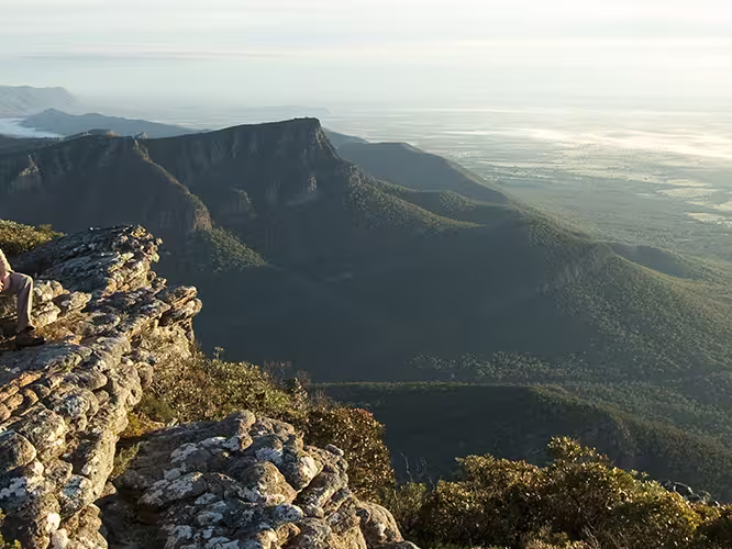 Travellers sitting on Baronia Peak in Grampians National Park, Victoria