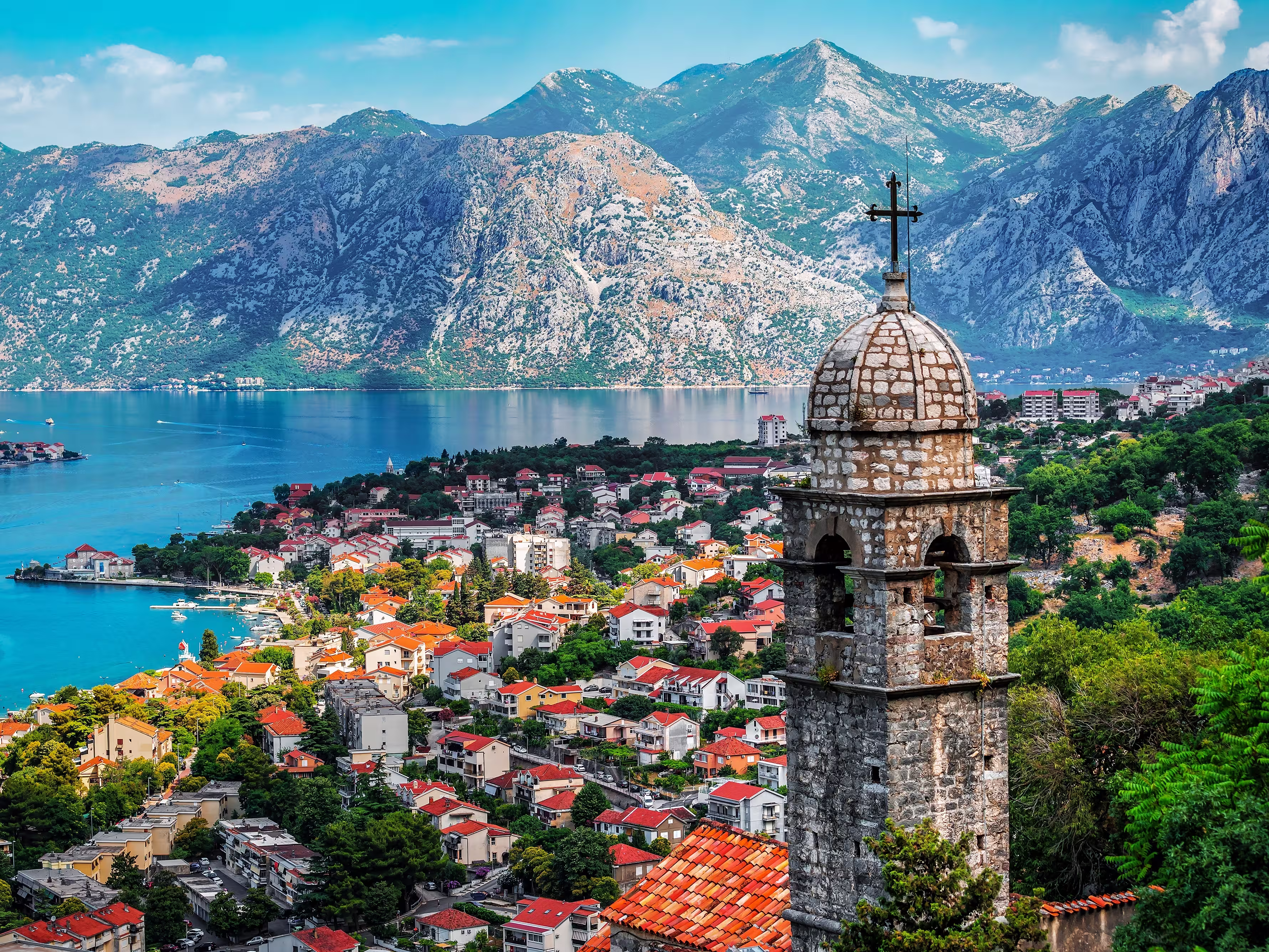 Bell tower of Church Our Lady of Remedy on the hill tower in the old city of Kotor and the Kotor Bay in Montenegro. Travel and vacation theme